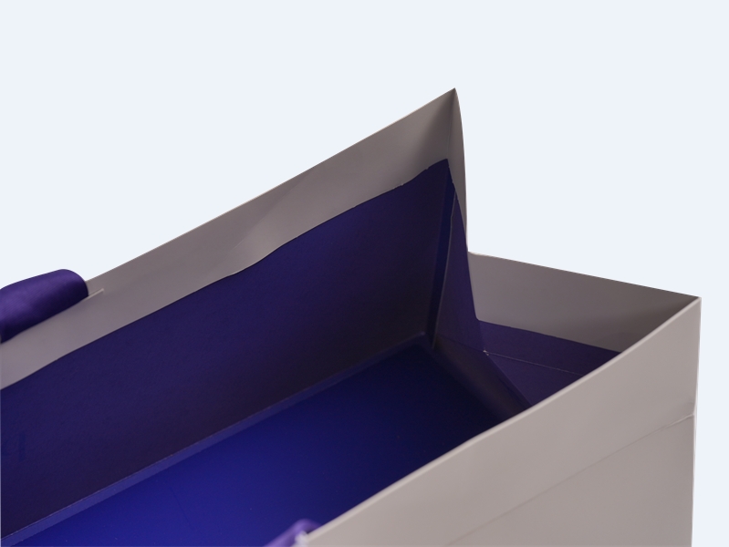 White and Blue Customized Paper Bags with Blue Ribbon